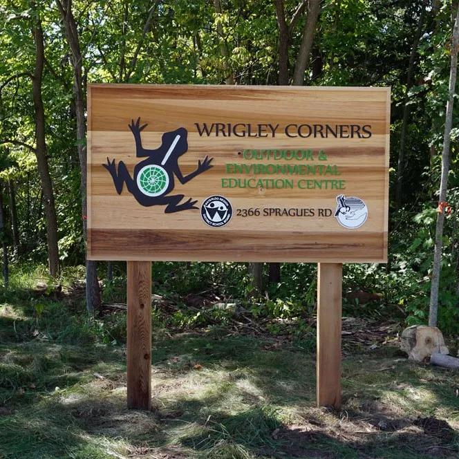 A post and wood panel sign that gives information about a nature reserve