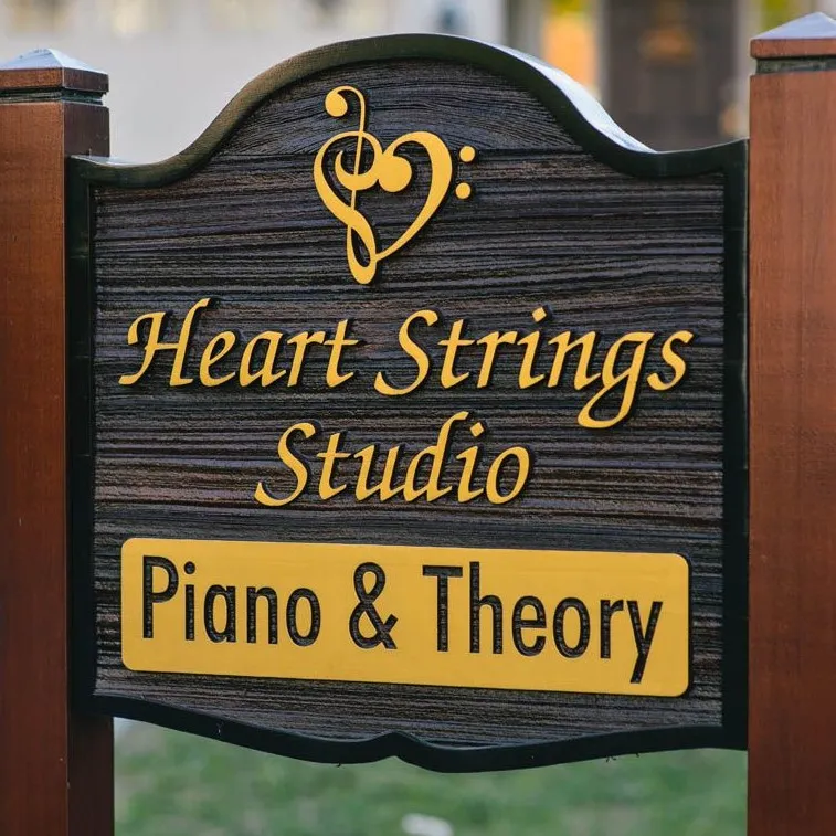a sandblased wood sign panel sign on wood posts, advertising a piano studio