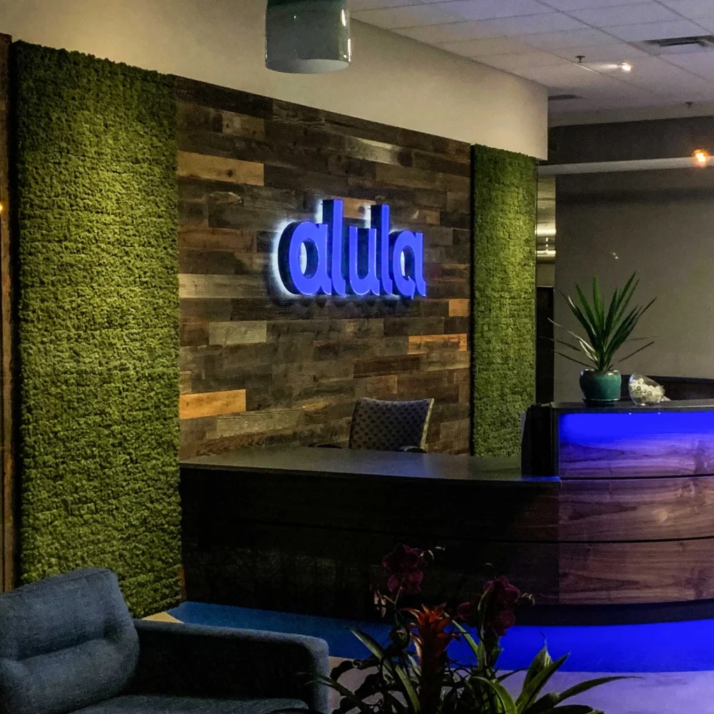 Rear lit channel letter sign installed at a reception desk.