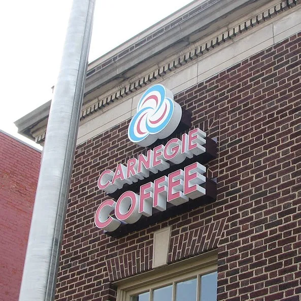 A channel letter sign and logo installed on exterior brick wall.