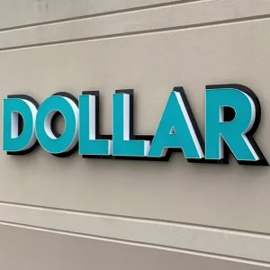 A channe letter sign with blue face installed on exterior wall.