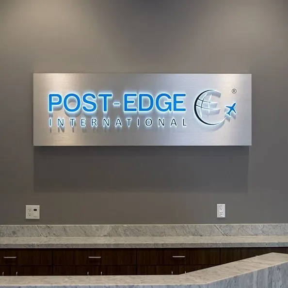 Push thru sign with blue acrylic letters with white lighting on silver sign box.